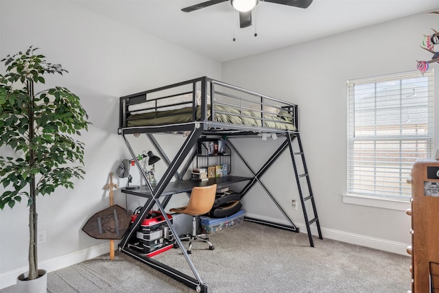 carpeted bedroom with baseboards and a ceiling fan