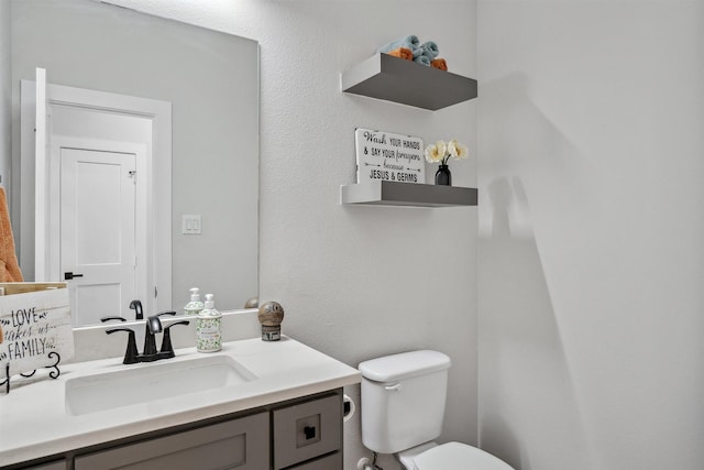 half bath featuring toilet and vanity