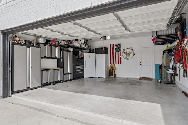 garage with a garage door opener and freestanding refrigerator