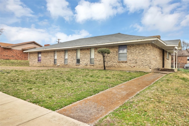 view of front of house featuring a front yard and brick siding