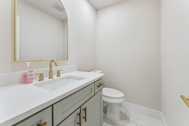 bathroom with vanity, baseboards, visible vents, toilet, and marble finish floor