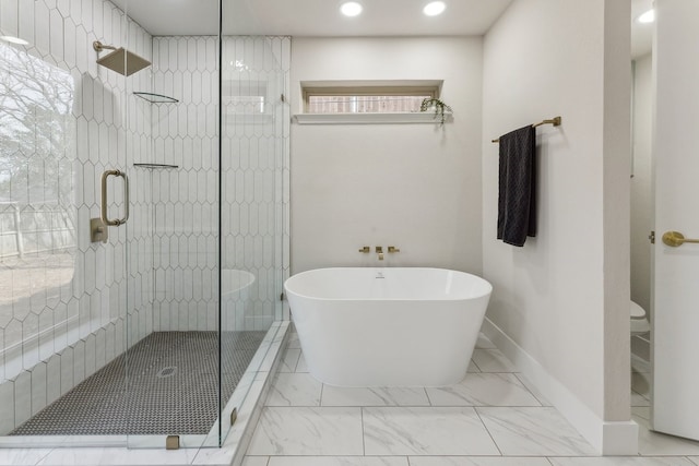 full bath featuring a freestanding tub, marble finish floor, and a stall shower