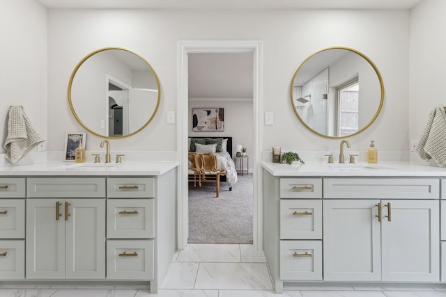 ensuite bathroom featuring a sink, two vanities, and marble finish floor