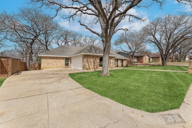 view of front of home featuring fence, concrete driveway, a front yard, a garage, and brick siding