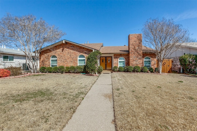 single story home with a front yard, central AC unit, brick siding, and a chimney