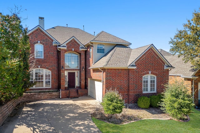 traditional-style home with driveway, brick siding, roof with shingles, and a chimney