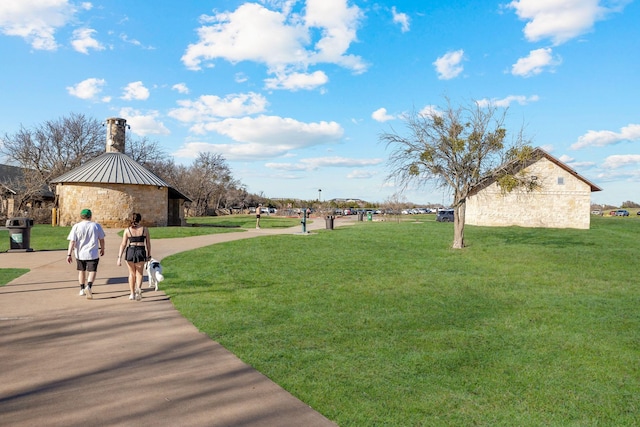 view of home's community with a yard