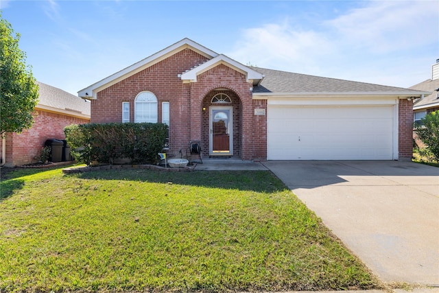 ranch-style house featuring brick siding, an attached garage, a front yard, roof with shingles, and driveway