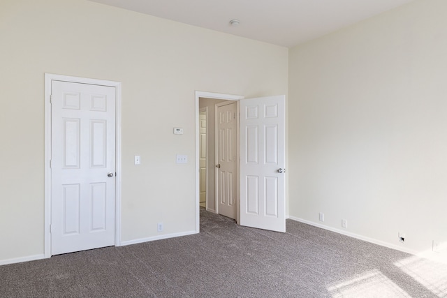 unfurnished bedroom featuring carpet flooring and baseboards