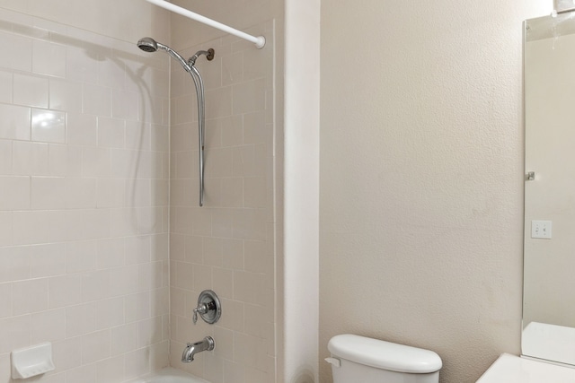 bathroom featuring toilet and shower / bathtub combination