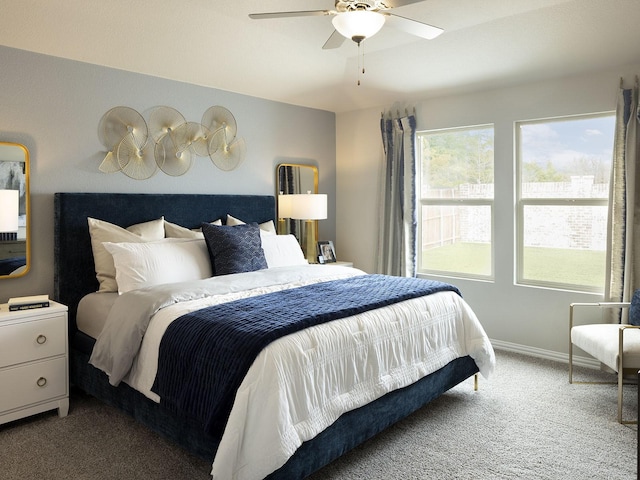 carpeted bedroom with baseboards and ceiling fan