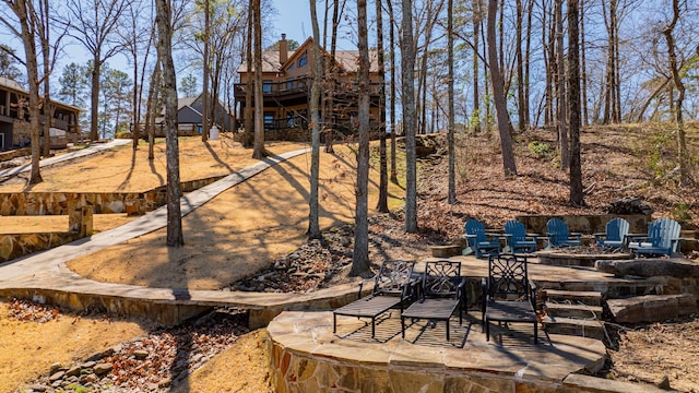 view of yard with an outdoor fire pit and a patio