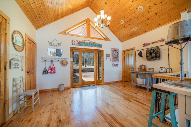 foyer with baseboards, a chandelier, wood ceiling, hardwood / wood-style flooring, and high vaulted ceiling