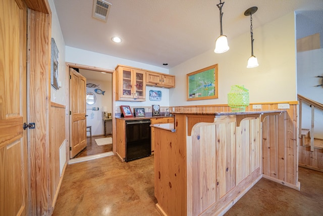 kitchen with a breakfast bar area, visible vents, black dishwasher, glass insert cabinets, and decorative light fixtures