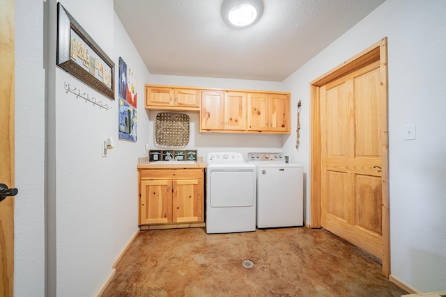 laundry room with washer and dryer, cabinet space, baseboards, and a sink