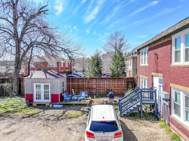 view of yard featuring an outbuilding, fence, and a wooden deck