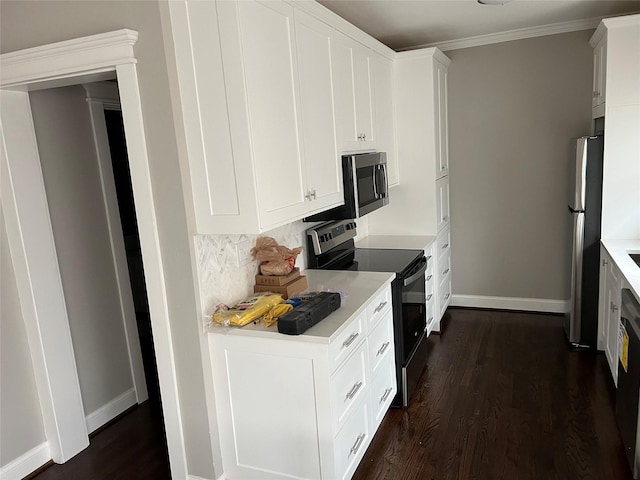 kitchen featuring dark wood-style floors, baseboards, stainless steel appliances, light countertops, and white cabinetry