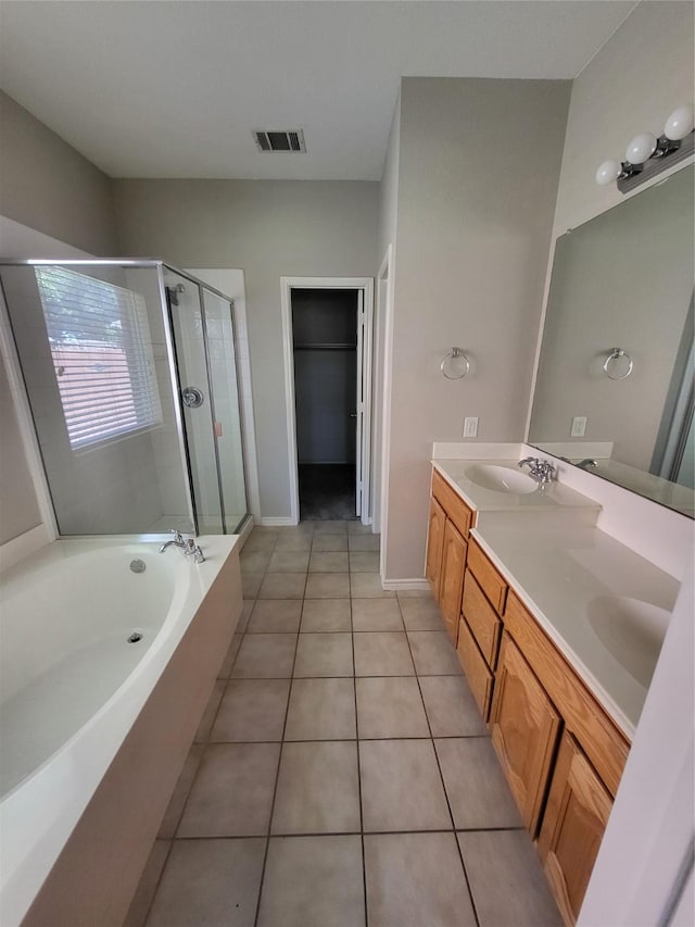 full bath featuring visible vents, a stall shower, a bath, tile patterned floors, and a sink