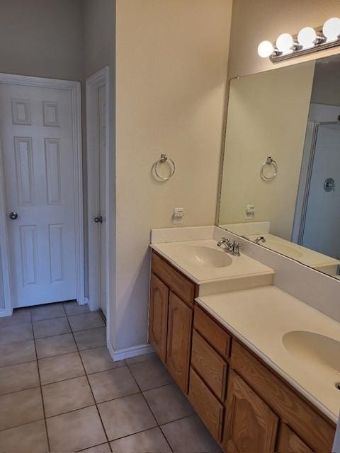 bathroom featuring a sink, double vanity, and tile patterned floors