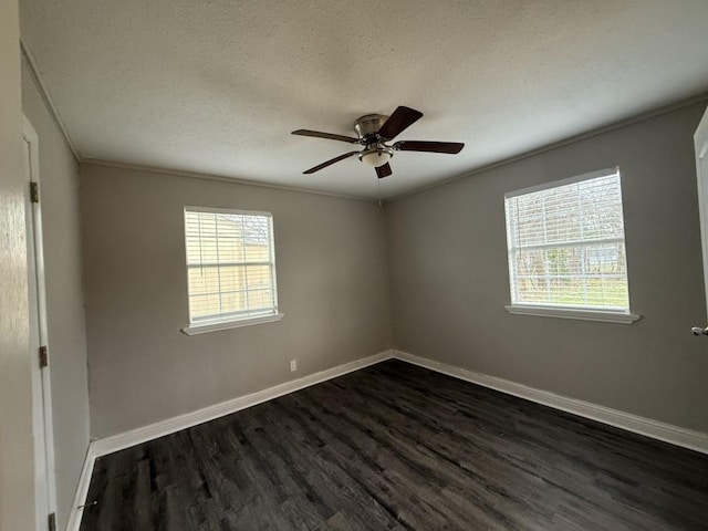 spare room featuring a ceiling fan, baseboards, dark wood-style flooring, and a textured ceiling