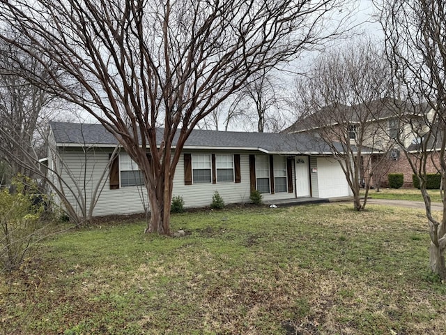 ranch-style home featuring driveway, a front lawn, and an attached garage