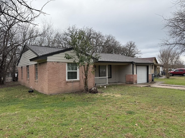 ranch-style house featuring a front lawn, a garage, and brick siding