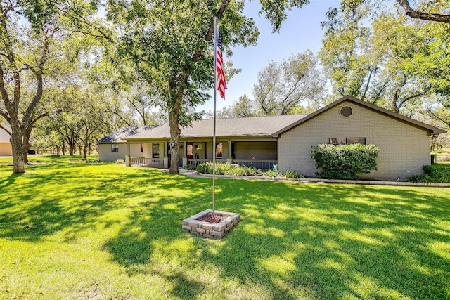 ranch-style house featuring brick siding and a front yard