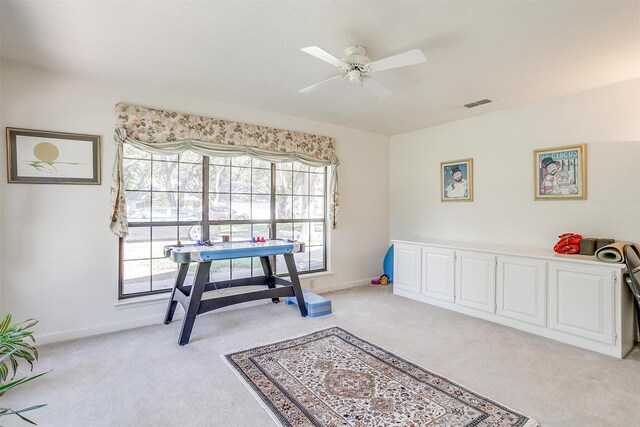 interior space with ceiling fan, baseboards, visible vents, and light carpet