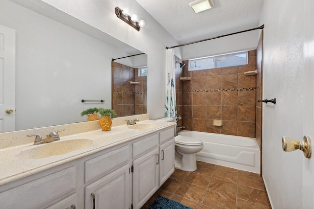 full bath featuring a textured ceiling, shower / tub combo, toilet, and a sink