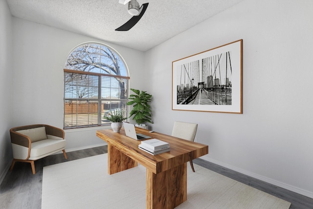 office area with baseboards, a textured ceiling, and wood finished floors