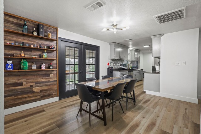 5621 Rocky Ridge Rd, Dallas, TX 75241 - dining room featuring visible vents, light wood finished floors, and french doors