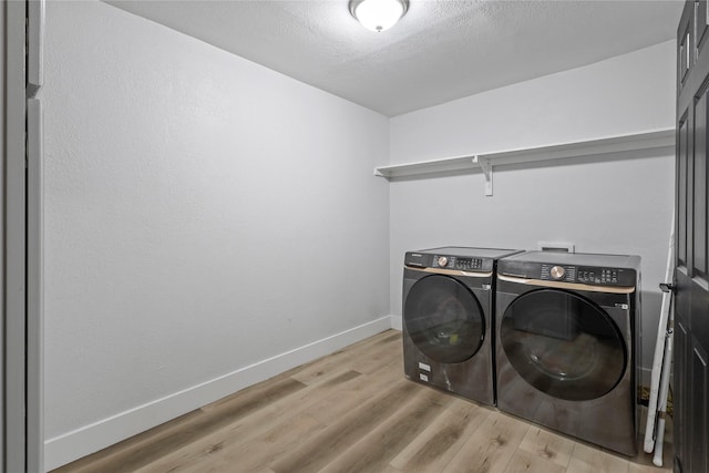 5621 Rocky Ridge Rd, Dallas, TX 75241 - washroom featuring light wood-type flooring, baseboards, independent washer and dryer, and laundry area