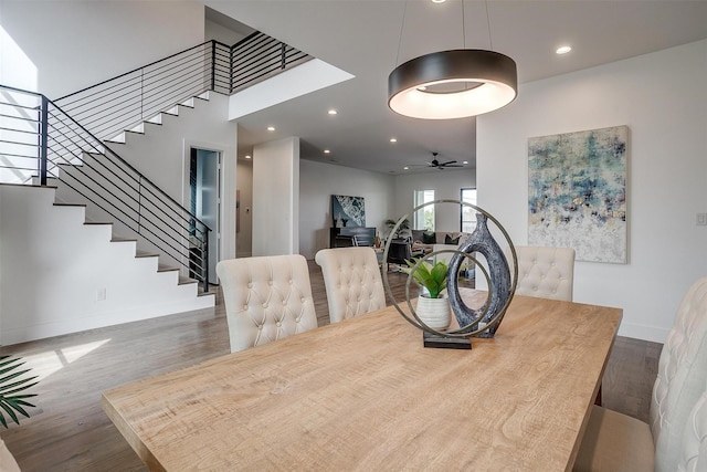 dining area with stairway, recessed lighting, baseboards, and wood finished floors