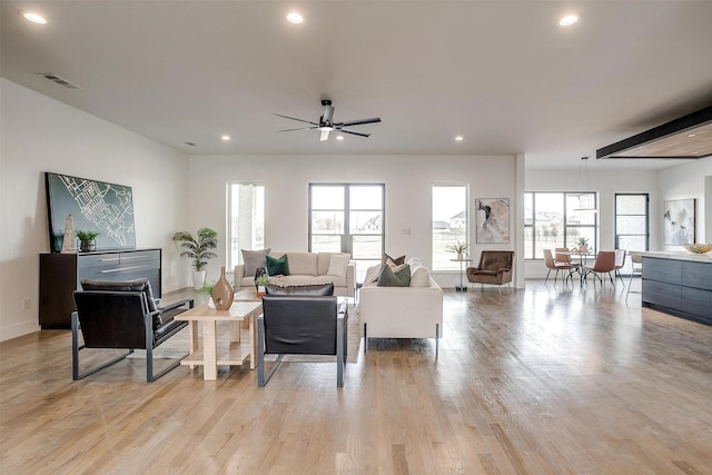 living room featuring recessed lighting, visible vents, and light wood finished floors