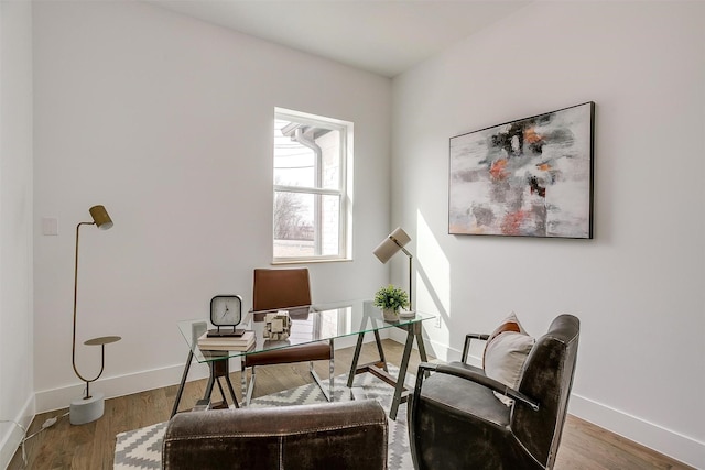 home office featuring baseboards and wood finished floors