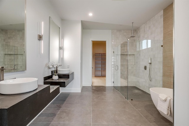 full bath with baseboards, recessed lighting, a freestanding bath, tile patterned flooring, and a shower stall