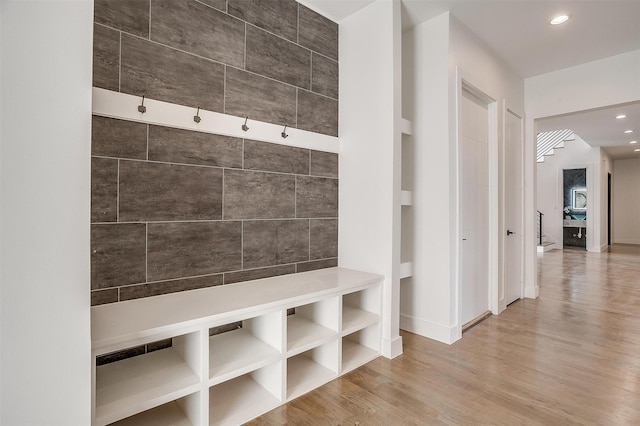 mudroom with recessed lighting, baseboards, and wood finished floors