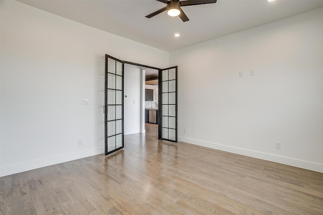 unfurnished room featuring a ceiling fan, recessed lighting, wood finished floors, and baseboards