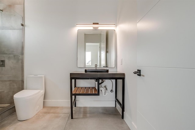 bathroom featuring concrete floors, baseboards, toilet, a stall shower, and vanity