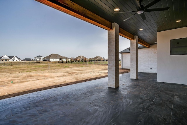 view of patio / terrace with fence, a residential view, and ceiling fan