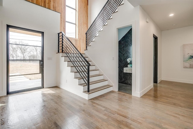 entryway featuring stairway, recessed lighting, baseboards, and light wood-type flooring