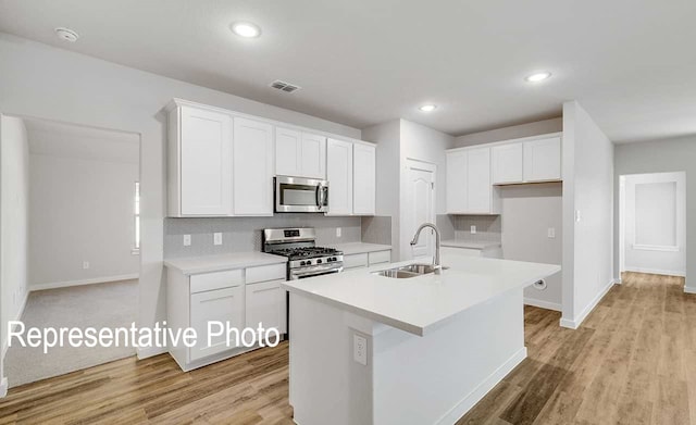 kitchen with a sink, visible vents, backsplash, and appliances with stainless steel finishes