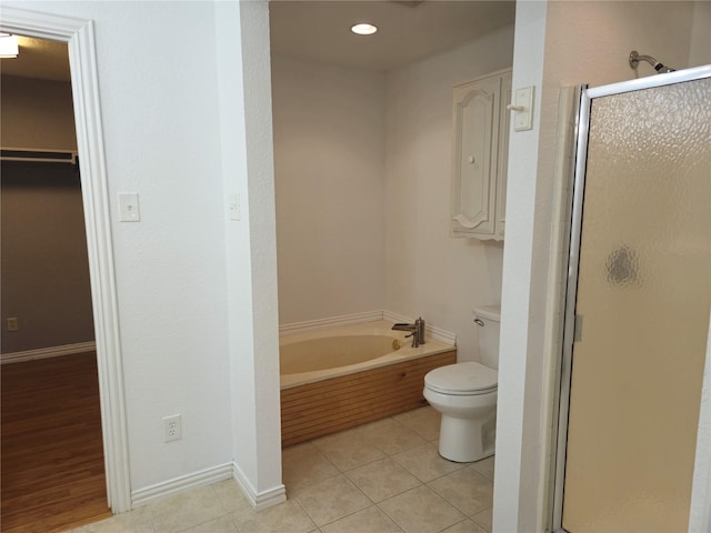 full bathroom with tile patterned flooring, a shower stall, and a garden tub