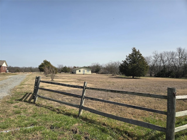 view of yard with a rural view and fence