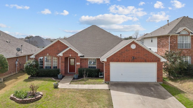 traditional-style house with driveway, a shingled roof, an attached garage, a front yard, and brick siding