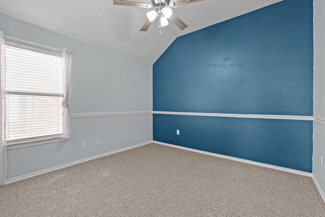 unfurnished room with lofted ceiling, carpet flooring, baseboards, and ceiling fan