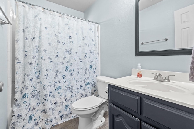 full bathroom with toilet, wood finished floors, and vanity