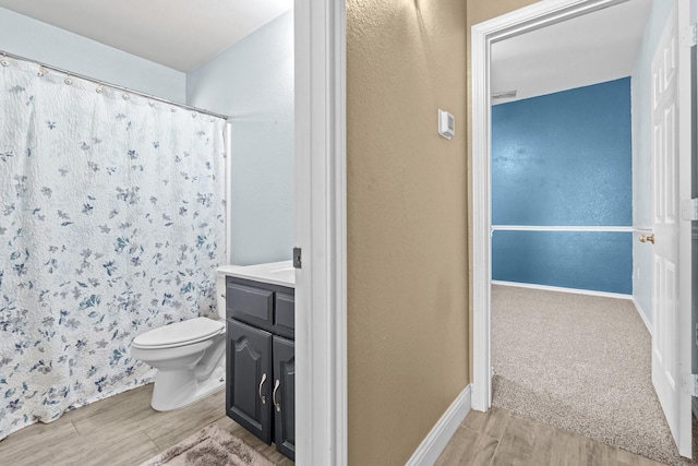 full bath with toilet, vanity, a shower with curtain, and wood tiled floor