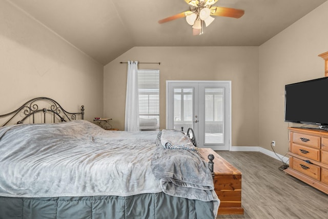 bedroom featuring baseboards, vaulted ceiling, french doors, wood finished floors, and access to outside