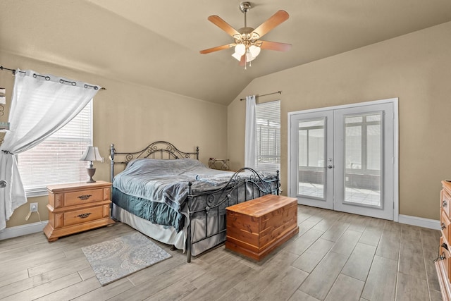 bedroom with baseboards, wood finish floors, lofted ceiling, french doors, and access to outside